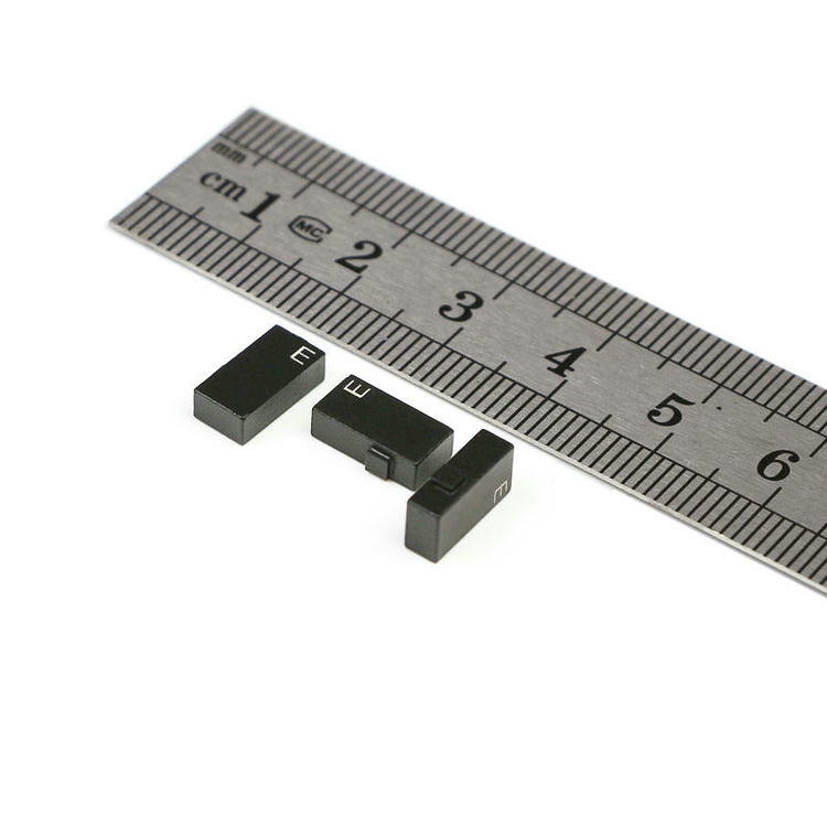 A small C1005-1 ceramic RFID tag is held on a fingertip to visually demonstrate its compact 10x5mm dimensions.