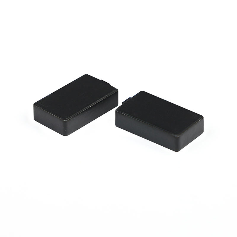 A tiny C1207-1 ceramic RFID tag is held on a fingertip to demonstrate its ultra compact dimensions of 12x7mm.